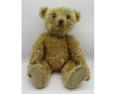 Steiff 1909 teddy bear in apricot mohair, with centre seam, boot button eyes, pronounced clipped muzzle, card lined feet, hum