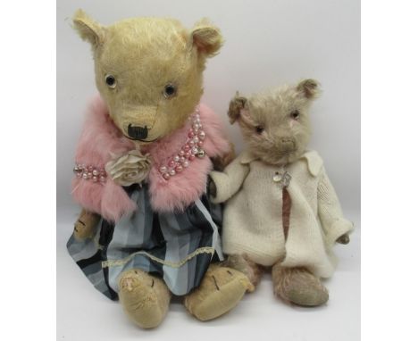 Chiltern c. 1930s teddy bear in pink mohair with glass eyes, swivel head, jointed arms and legs, wearing a pink stole and ski