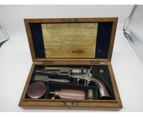 Birds eye maple cased colt pocket pistol with elaborate scrolled engraving to the frame barrel and coaching scenes to the cyl