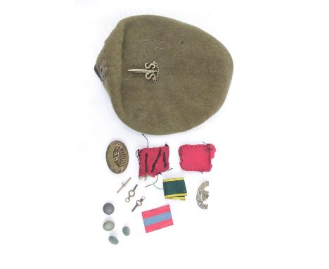 Collection of assorted Brass Military Badges inc. Commando SAS, Cambridge Regiment etc and a Army Khaki Beret. 