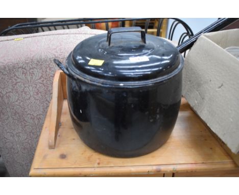 A traditional travel or stove cooking pot in black enamel