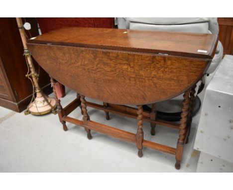 A traditional oak twist gate leg dining table, width approx. 107cm