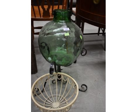 A carboy on stand and a planter holder