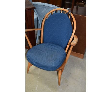 A vintage Ercol low carver chair having typical hoop and stick back design