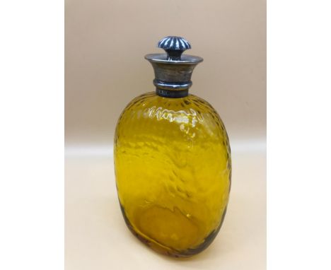 A fine example of an amber decanter topped with a Birmingham silver rim. Comes with an ornate stopper. Makers Hukin &amp; Hea