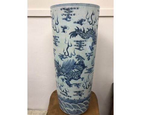 A Beautiful example of a large Oriental blue and white dragon design vase/ walking stick pot. Measures 64.5cm in height 