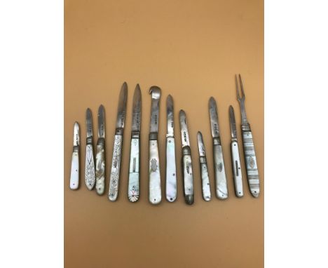 A lot of 12 Silver hall marked and mother of pearl fruit/ pen knifes. Includes Georgian silver and mother of pearl pickle for