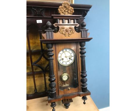 A Victorian enamel and brass faced wall clock, running condition. Measures 88cm in height. 