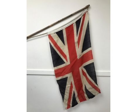 A Vintage Union Jack flag with a bamboo stick. 