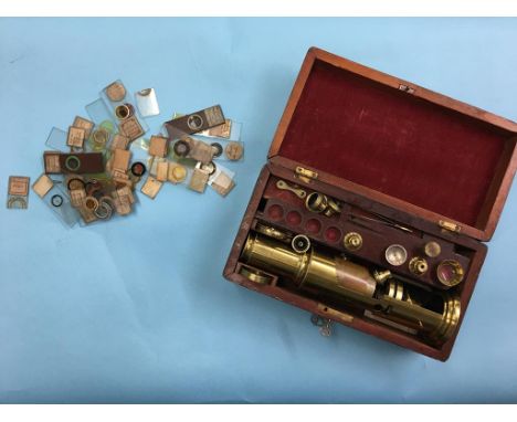 A brass field microscope and various lenses, in fitted mahogany case