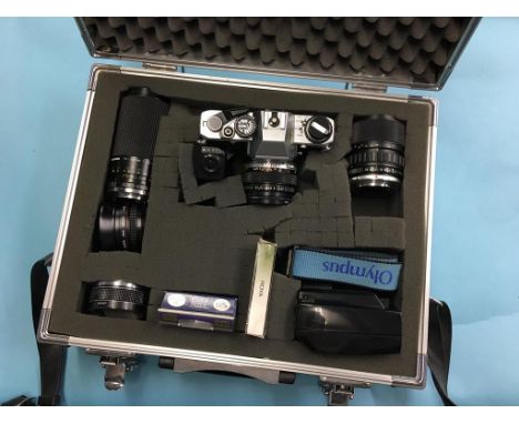 An Olympus camera, with various lenses and accessories, in flight case