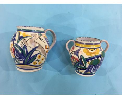 A Poole pottery milk jug and a two handled vase