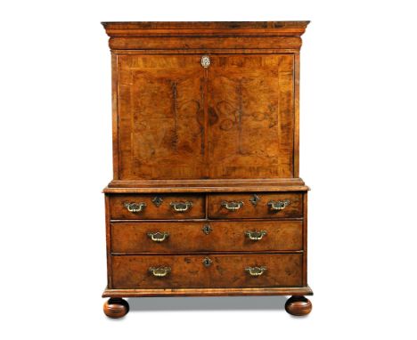 A Queen Anne walnut escritoire, early 18th century, the fall and drawer fronts with mirrored figured walnut veneers within fe