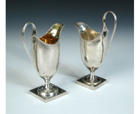 A George III silver helmet creamer, maker S? (marks rubbed), London 1786, the plain body with beaded edge raised on a square 