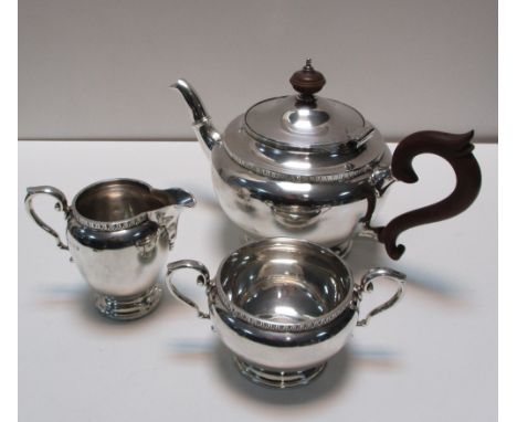 A small silver three piece tea set, by the Adie Brothers, Birmingham 1926, comprising:- a teapot of plain circular shape with