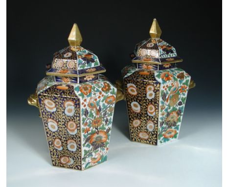 A pair Of Chamberlain's Worcester imari two-handled vases and covers, of hexagonal form, with gilt spire finials and gilt fis