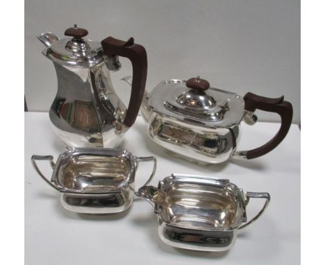 A silver three piece tea set together with a silver hotwater jug, by C W Fletcher & Son Ltd, Sheffield 1934, comprising a tea