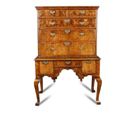 A Queen Anne walnut chest on stand, early 18th century with moulded cornice, featherbanded decoration to the drawer fronts, l