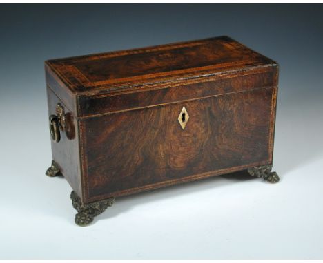 A Regency figured veneer tea caddy, in rosewood, walnut, kingwood, satinwood and yew, with gilt brass loop handles and lion p