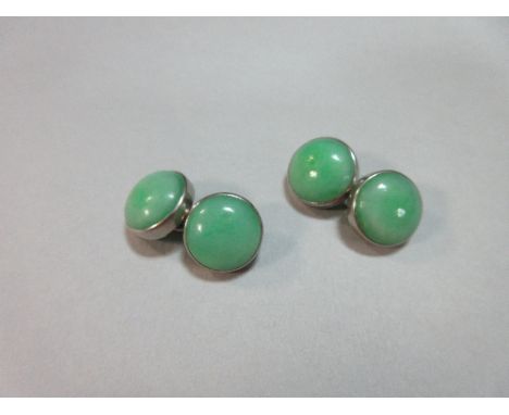 A pair of jade double-ended cufflinks, each end a round cabochon of mid-green jade with apple green speckles, in a plain coll
