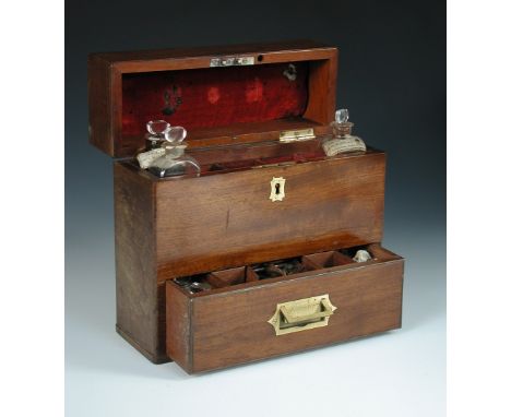 A 19th century mahogany domestic medicine chest, the hinged cover opening to reveal a fitted interior with three original bot