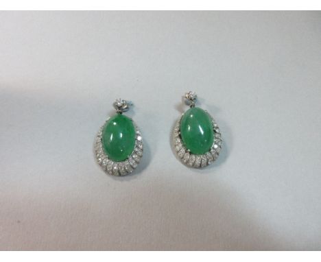 A pair of mid-20th century jadeite jade and diamond earrings, each post headed by a round brilliant cut diamond and suspendin