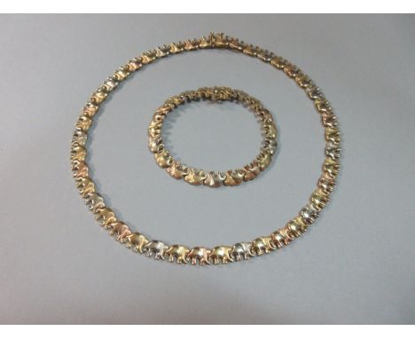 An Italian 18ct tri-colour gold elephant necklace and bracelet suite, each designed as a continuous line of uniform elephant 