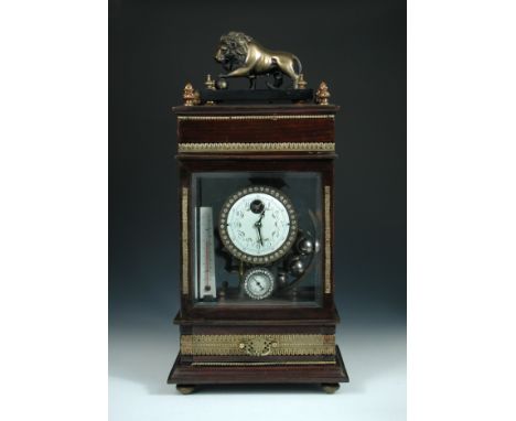 A 20th century novelty 'ferris wheel' mantel clock, the glazed stained wood case with lion surmount, balance wheel movement h