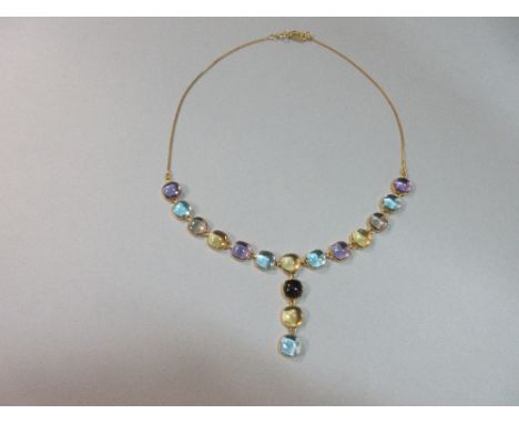 An 18ct gold and multi gem necklace, set to the front with a line of alternating pastel shades of cushion shaped cabochon sto