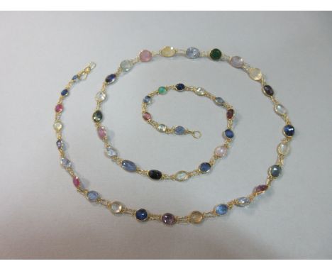 A tutti-frutti gem set necklace, designed as a graduated line of spectacle set oval and round cut multi-coloured gems, princi