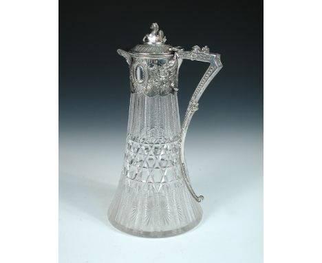 A Victorian electroplate mounted cut glass claret jug, the extended bell shaped glass body below a floral decorated plate mou