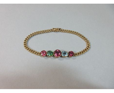An antique gem set bracelet, set to the front with a graduated line of five gemstones all in millegrain collets, with three r