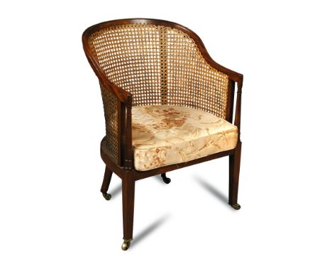 A Regency style mahogany library bergere, 20th century with caned back and sides, loose cushion seat, on tapering square legs
