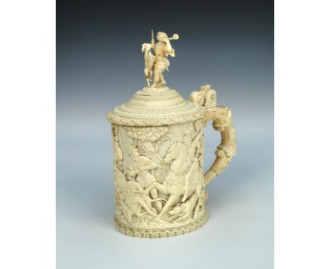 A 19th century German carved ivory lidded hunting tankard, circa 1880, the hinged lid with finial carved as a bugle carrying 