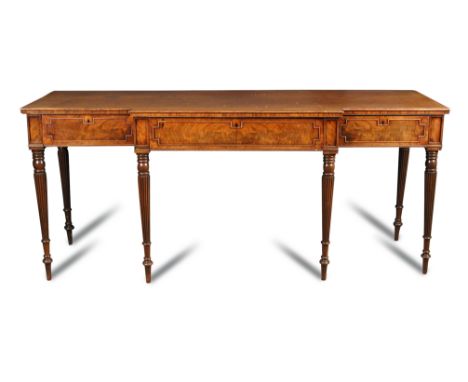 A 19th century mahogany breakfront serving table in the manner of Gillow with moulded edge and three drawers, each with outli