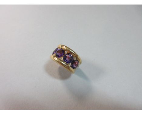 An unusual amethyst, diamond and 18ct gold band ring, set to the front with a line of four hexagonal step cut amethysts with 