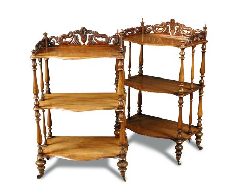 A pair of Victorian walnut etagere, mid 19th century, of three shaped shelves, with carved three quarter galleried tops and f