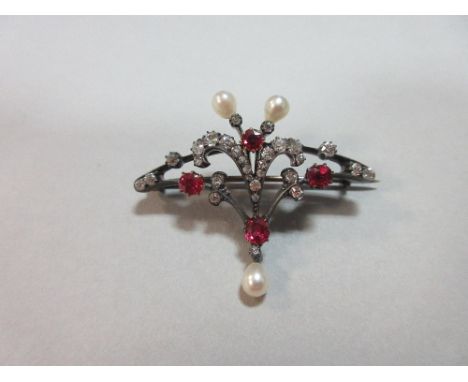 A diamond, ruby and pearl brooch, of loosely fan-shaped outline and open, slightly asymmetrical design, with a plume of gradu