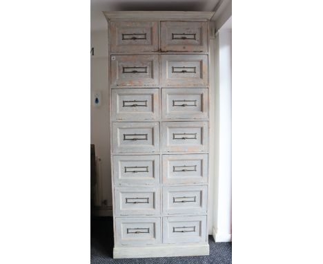 A light grey painted pine tall office cabinet enclosed by seven pairs of fall-front panel doors, &amp; on a plinth base, 37” 