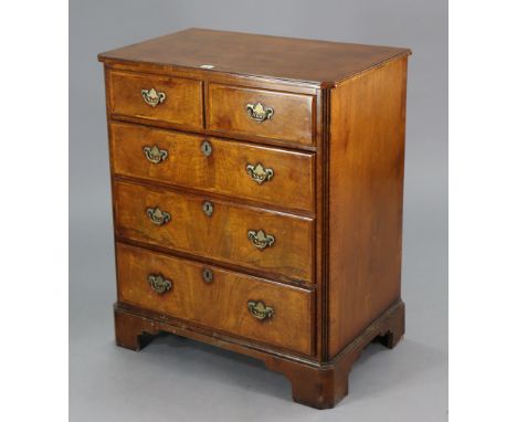 A walnut-finish upright cabinet enclosed by a hinged lift-lid, with fall-front mock-drawers, &amp; on bracket feet, 28¼” wide