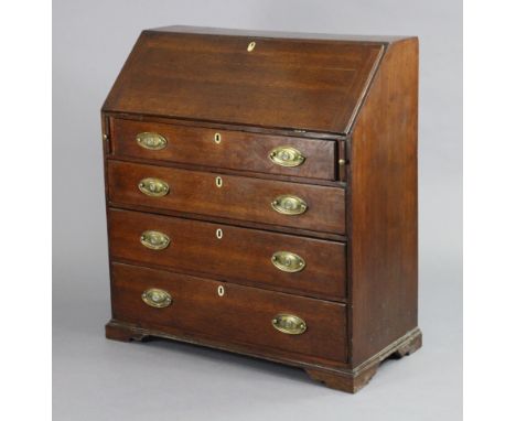 A Georgian oak bureau, with fitted interior enclosed by sloping fall-front above four long graduated drawers with oval brass 