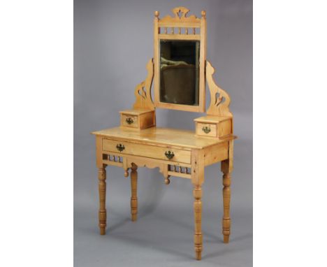 A pine dressing table with a rectangular swing mirror to the stage back, fitted frieze drawer, &amp; on turned legs, 36” wide