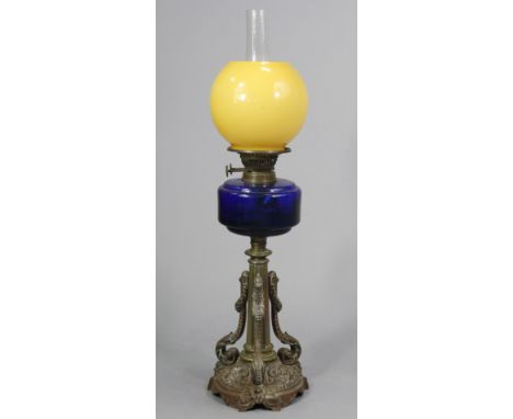 A late 19th/early 20th century cast-brass oil table lamp with a blue glass reservoir, &amp; on a fluted round centre column &