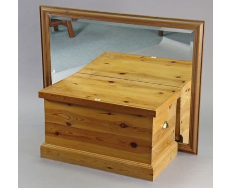 A pine blanket box with a hinged lift-lid, with brass cup side handles, &amp; on a plinth base, 30” wide x 17¼” high &amp; a 