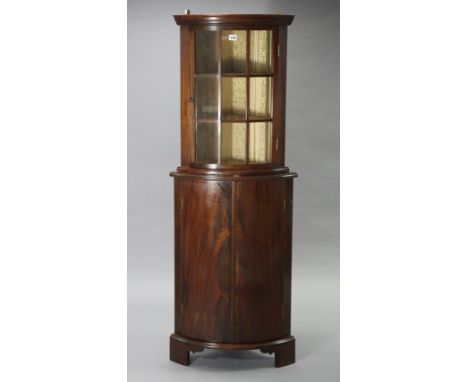 A mahogany small bow-front hanging corner cabinet fitted two shelves enclosed by a glazed door, 20” wide x 26” high; &amp; a 