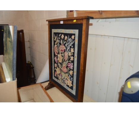 An oak and embroidered firescreen