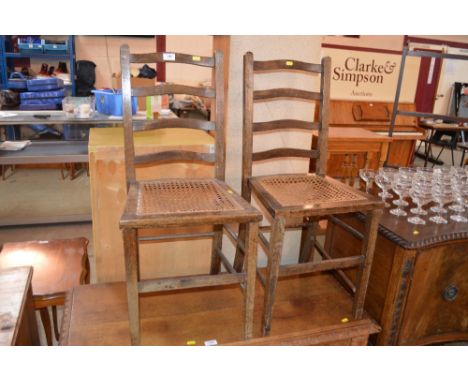 A pair of oak ladder back cane seated bedroom chairs 