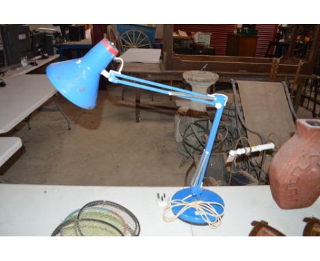 A blue angle poise style lamp 