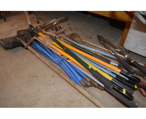 A quantity of garden tools including spears, axe and a set of drainage rods