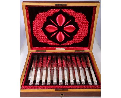 Set of twelve early 20th century fruit knives and forks with plated blades and mother-of-pearl handles, carved box bearing Ma